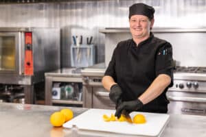 Chef slicing oranges in Western Slope's kitchen