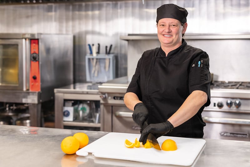Chef slicing oranges in Western Slope's kitchen